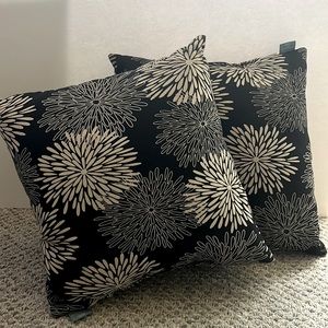 TWO matching accent pillows. Black and light tan with flower design.